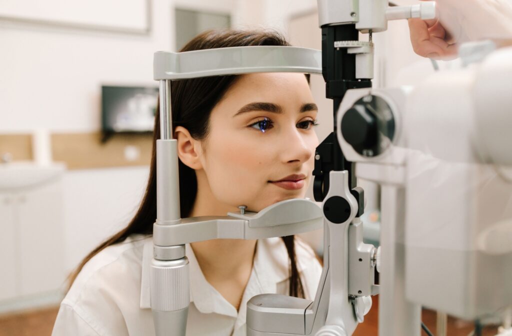 A woman undergoes a slit lamp test during an eye exam