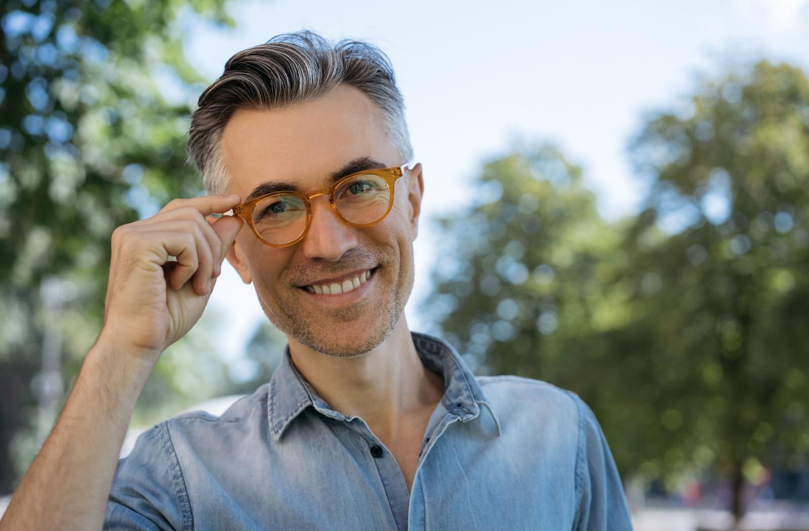 A person wearing a pair of trendy glasses while outside